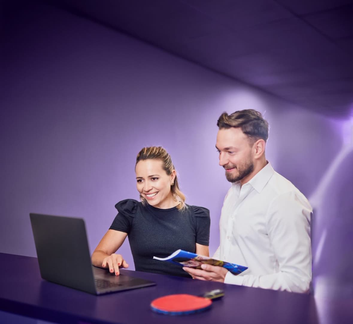 TTTOK event planning with laptop, table tennis racket and two people